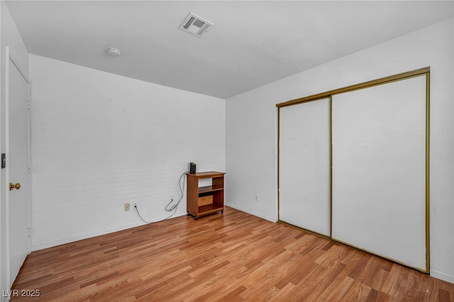 2165 Saint Paul Way, Las Vegas, NV 89104 - unfurnished bedroom with light wood-style floors and a closet