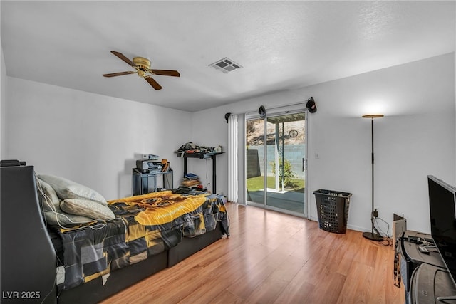 2165 Saint Paul Way, Las Vegas, NV 89104 - bedroom with access to exterior, wood finished floors, and ceiling fan