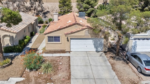 2165 Saint Paul Way, Las Vegas, NV 89104 - view of front of home featuring driveway, a garage, and stucco siding