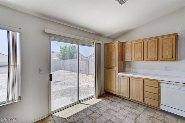 5917 Briar Rose Ln, Las Vegas, NV 89130 - kitchen with white dishwasher, vaulted ceiling, and tile countertops