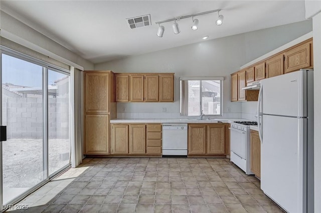 5917 Briar Rose Ln, Las Vegas, NV 89130 - kitchen featuring white appliances, lofted ceiling, healthy amount of natural light, and under cabinet range hood