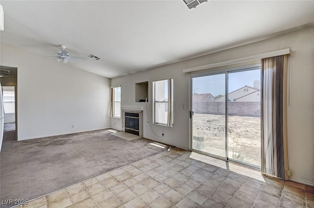 5917 Briar Rose Ln, Las Vegas, NV 89130 - unfurnished living room with ceiling fan, a tile fireplace, carpet flooring, and lofted ceiling