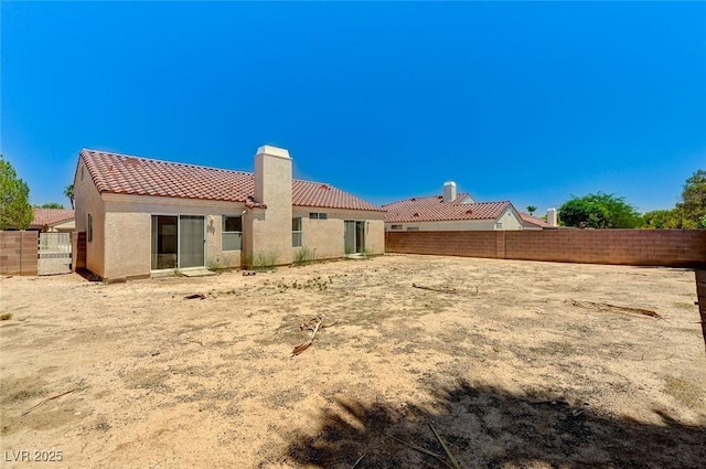 5917 Briar Rose Ln, Las Vegas, NV 89130 - back of property featuring a tiled roof, stucco siding, and a chimney
