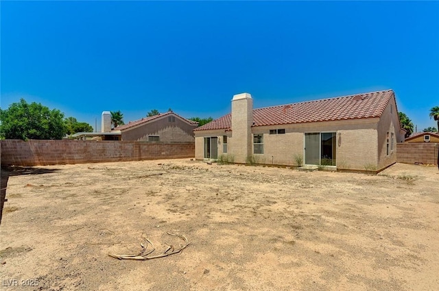 5917 Briar Rose Ln, Las Vegas, NV 89130 - back of house featuring a tile roof, stucco siding, and a chimney