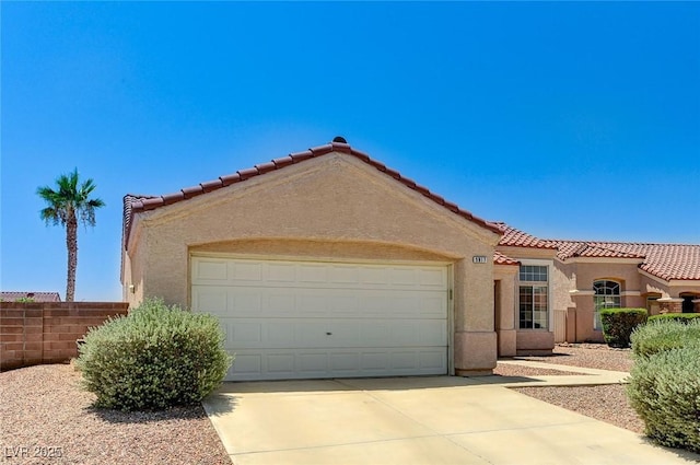 5917 Briar Rose Ln, Las Vegas, NV 89130 - mediterranean / spanish house with concrete driveway, stucco siding, an attached garage, and a tile roof