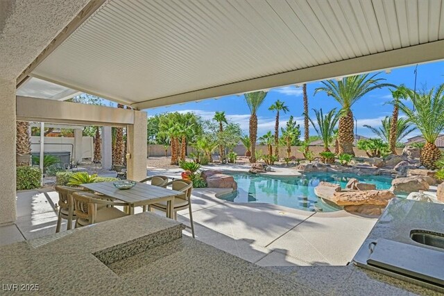 328 Hedgehope Dr, Las Vegas, NV 89183 - outdoor pool featuring a patio area, a fenced backyard, a jacuzzi, and outdoor dining area