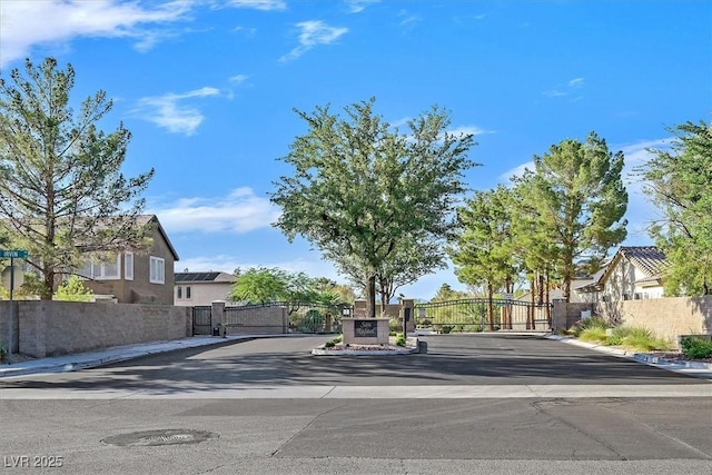 328 Hedgehope Dr, Las Vegas, NV 89183 - view of asphalt road with a gate, curbs, a gated entry, and sidewalks