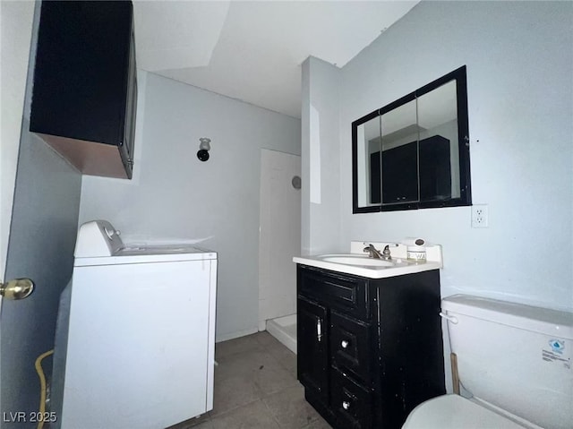 6120 Denver Cir, Las Vegas, NV 89107 - bathroom featuring washer / dryer, vanity, and tile patterned flooring