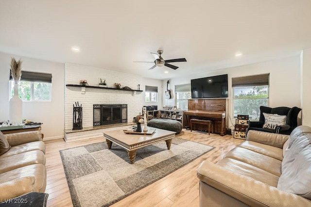 6140 Atwood Ave, Las Vegas, NV 89108 - living room with healthy amount of natural light, a ceiling fan, a brick fireplace, light wood-style flooring, and recessed lighting