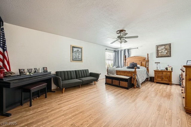 6140 Atwood Ave, Las Vegas, NV 89108 - bedroom with light wood finished floors, a textured ceiling, and a ceiling fan