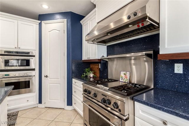 9380 Arrowhead Bluff Ave, Las Vegas, NV 89149 - kitchen featuring extractor fan, stainless steel appliances, white cabinets, light tile patterned floors, and recessed lighting