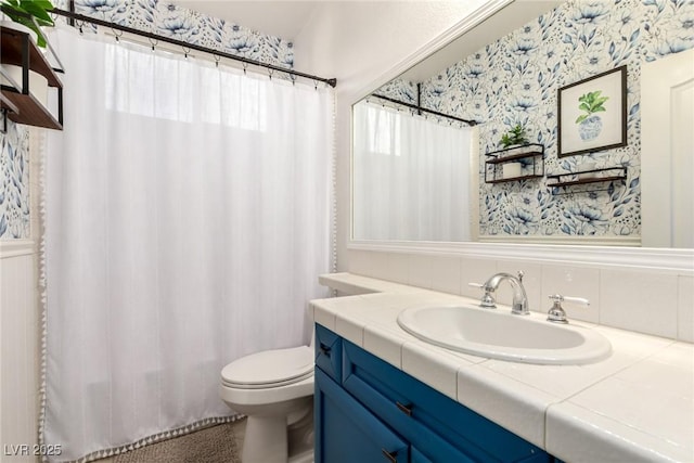 9380 Arrowhead Bluff Ave, Las Vegas, NV 89149 - bathroom with vanity, wallpapered walls, and decorative backsplash