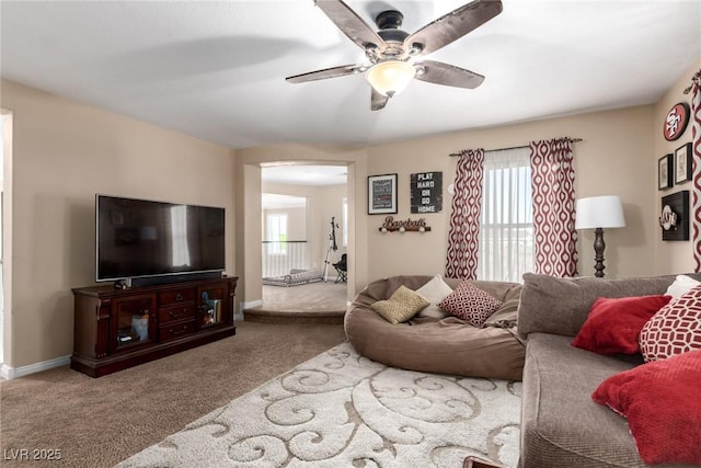 9380 Arrowhead Bluff Ave, Las Vegas, NV 89149 - living room with carpet floors, a ceiling fan, and arched walkways