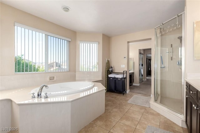 9380 Arrowhead Bluff Ave, Las Vegas, NV 89149 - full bath with healthy amount of natural light, vanity, a shower stall, and a garden tub