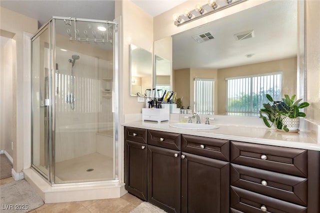 9380 Arrowhead Bluff Ave, Las Vegas, NV 89149 - bathroom featuring a stall shower, vanity, and tile patterned flooring