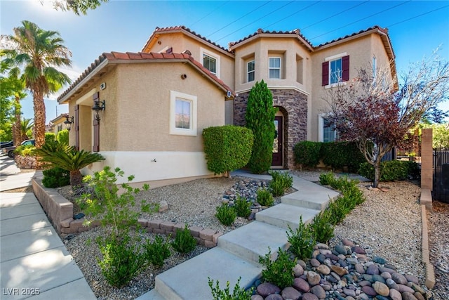 9380 Arrowhead Bluff Ave, Las Vegas, NV 89149 - mediterranean / spanish house with stucco siding, a tiled roof, and stone siding