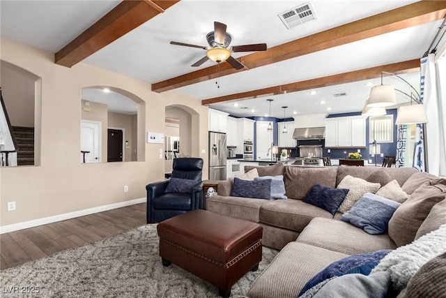 9380 Arrowhead Bluff Ave, Las Vegas, NV 89149 - living area featuring dark wood finished floors, a ceiling fan, beamed ceiling, recessed lighting, and arched walkways