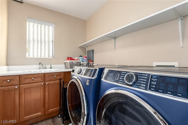 9380 Arrowhead Bluff Ave, Las Vegas, NV 89149 - laundry room with washing machine and clothes dryer, wood finished floors, and cabinet space