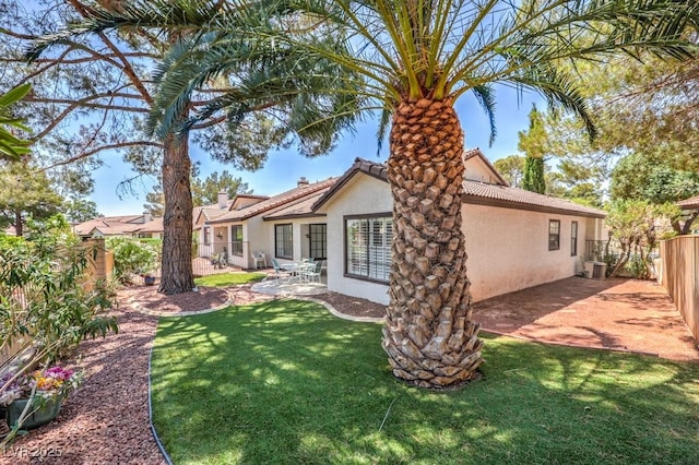 5320 Castle Harbor Ave, Las Vegas, NV 89130 - rear view of property featuring stucco siding, a fenced backyard, a patio area, a chimney, and a tile roof