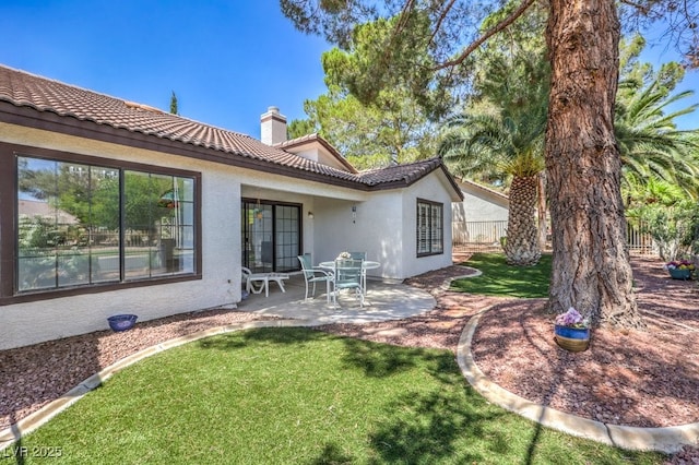 5320 Castle Harbor Ave, Las Vegas, NV 89130 - back of house with a patio area, stucco siding, a tiled roof, and a chimney