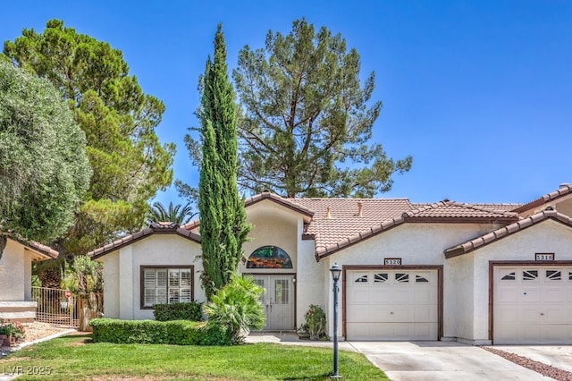5320 Castle Harbor Ave, Las Vegas, NV 89130 - mediterranean / spanish home with an attached garage, a tiled roof, concrete driveway, and stucco siding