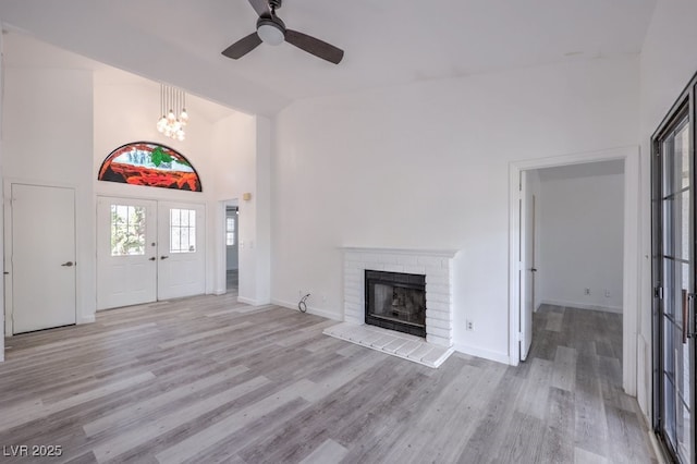 5320 Castle Harbor Ave, Las Vegas, NV 89130 - foyer with ceiling fan, wood finished floors, a fireplace, a chandelier, and high vaulted ceiling