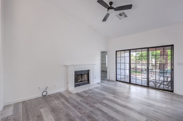 5320 Castle Harbor Ave, Las Vegas, NV 89130 - unfurnished living room featuring high vaulted ceiling, a ceiling fan, a brick fireplace, and wood finished floors