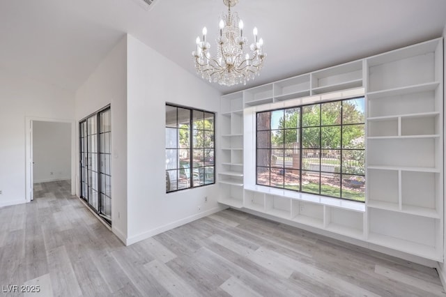 5320 Castle Harbor Ave, Las Vegas, NV 89130 - unfurnished dining area with a chandelier, wood finished floors, and vaulted ceiling