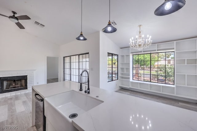 5320 Castle Harbor Ave, Las Vegas, NV 89130 - kitchen with open floor plan, a ceiling fan, vaulted ceiling, a brick fireplace, and light wood finished floors