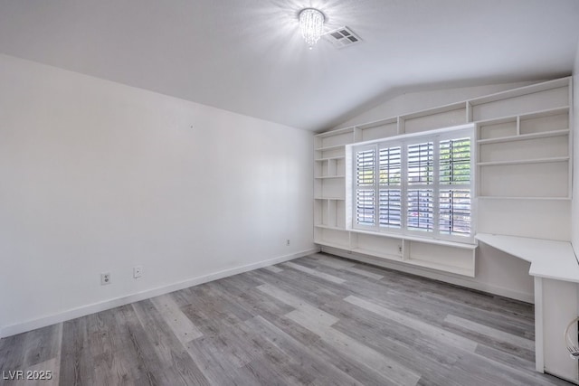 5320 Castle Harbor Ave, Las Vegas, NV 89130 - empty room with vaulted ceiling, wood finished floors, and built in shelves