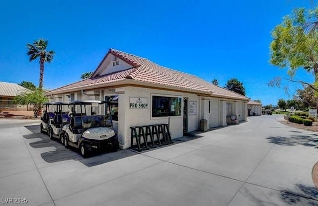 5320 Castle Harbor Ave, Las Vegas, NV 89130 - view of side of home featuring a tile roof and stucco siding