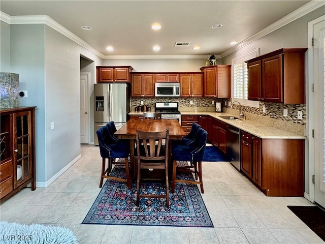 2132 Solvang Mill Dr, Las Vegas, NV 89135 - kitchen featuring appliances with stainless steel finishes, tasteful backsplash, ornamental molding, light tile patterned floors, and light stone countertops