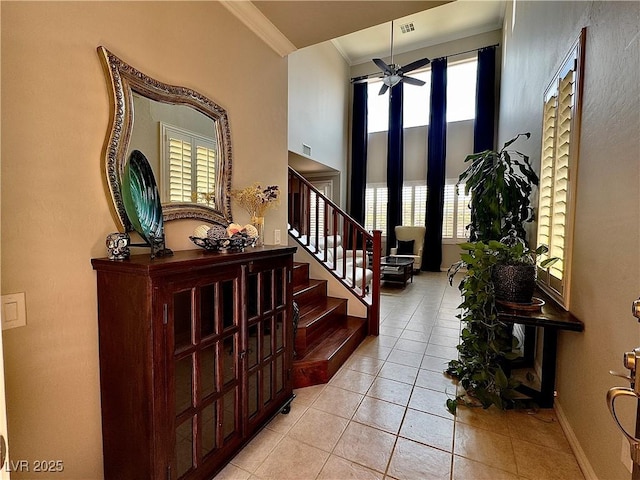 2132 Solvang Mill Dr, Las Vegas, NV 89135 - foyer entrance featuring crown molding, ceiling fan, light tile patterned flooring, and stairway