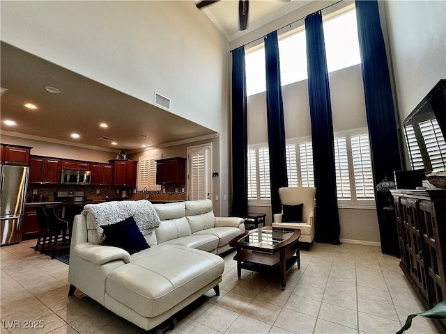 2132 Solvang Mill Dr, Las Vegas, NV 89135 - living room with ornamental molding, a high ceiling, and light tile patterned floors