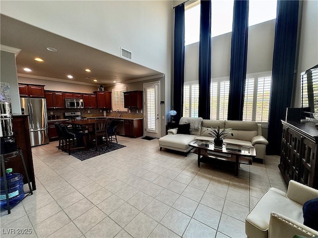 2132 Solvang Mill Dr, Las Vegas, NV 89135 - living area featuring a high ceiling, light tile patterned floors, ornamental molding, and recessed lighting