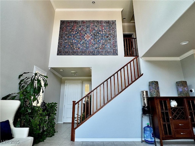 2132 Solvang Mill Dr, Las Vegas, NV 89135 - stairs featuring a high ceiling, ornamental molding, and tile patterned flooring