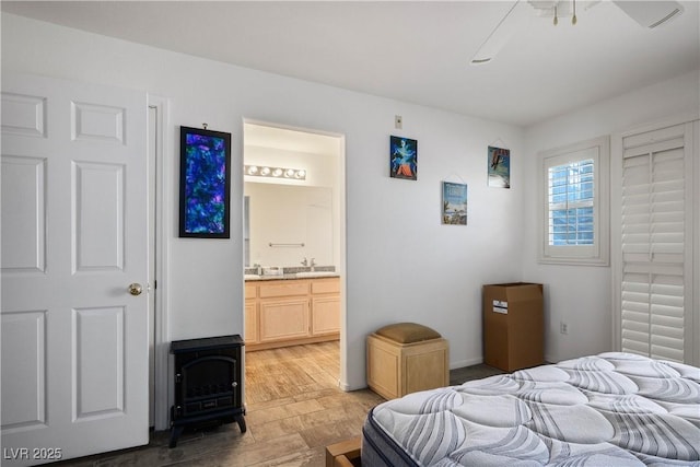 1809 Cutlass Dr Unit 0, Henderson, NV 89014 - bedroom featuring a wood stove, connected bathroom, and a ceiling fan