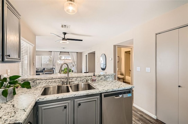 3125 N Buffalo Dr Unit 1090, Las Vegas, NV 89128 - kitchen with stainless steel dishwasher, ceiling fan, a peninsula, gray cabinetry, and dark wood-style floors