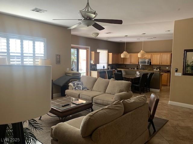 302 Doe Run, Henderson, NV 89012 - living area featuring a ceiling fan and light tile patterned flooring