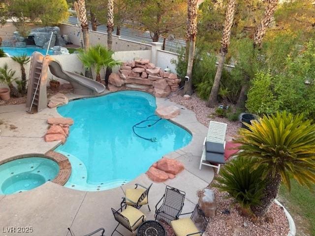 302 Doe Run, Henderson, NV 89012 - view of pool featuring a water slide, a fenced backyard, and a patio area