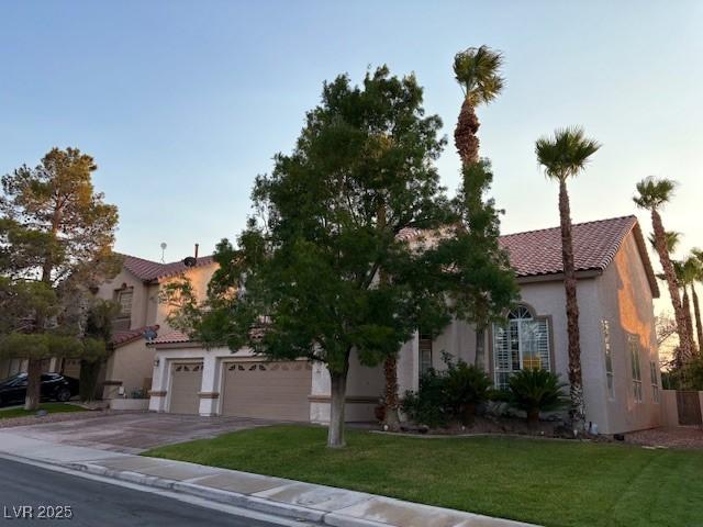 302 Doe Run, Henderson, NV 89012 - mediterranean / spanish-style house with a tiled roof, stucco siding, driveway, and a front lawn