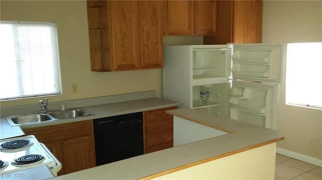 832 Hart Ave, Las Vegas, NV 89106 - kitchen with healthy amount of natural light, light countertops, dishwasher, and brown cabinets