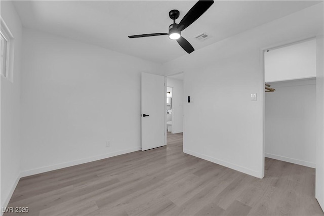 1317 Pyramid Dr, Las Vegas, NV 89108 - unfurnished bedroom featuring a spacious closet, light wood finished floors, and a ceiling fan