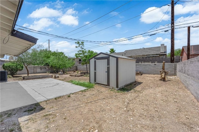 1317 Pyramid Dr, Las Vegas, NV 89108 - fenced backyard with a patio area and a storage unit