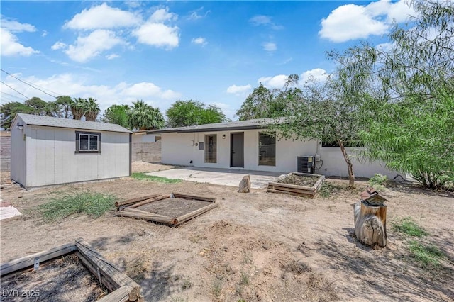 1317 Pyramid Dr, Las Vegas, NV 89108 - rear view of property with a vegetable garden and a shed