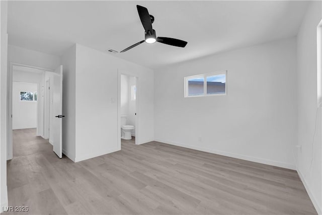 1317 Pyramid Dr, Las Vegas, NV 89108 - unfurnished bedroom featuring light wood finished floors, multiple windows, ensuite bathroom, and a ceiling fan