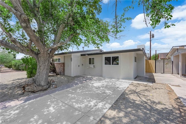 1317 Pyramid Dr, Las Vegas, NV 89108 - view of front of house with stucco siding and a gate