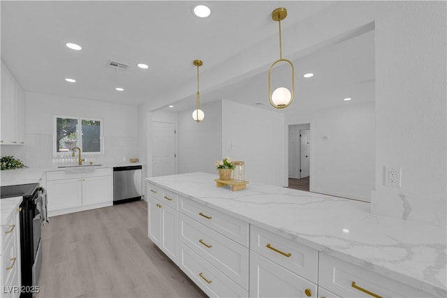 1317 Pyramid Dr, Las Vegas, NV 89108 - kitchen with stainless steel dishwasher, electric range, white cabinets, recessed lighting, and light stone counters