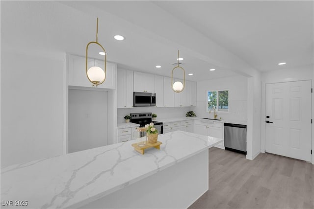 1317 Pyramid Dr, Las Vegas, NV 89108 - kitchen featuring appliances with stainless steel finishes, white cabinetry, light wood-style floors, pendant lighting, and recessed lighting