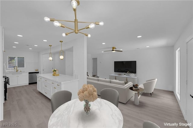 1317 Pyramid Dr, Las Vegas, NV 89108 - dining room featuring a chandelier, light wood-style floors, recessed lighting, and ceiling fan